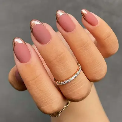 French manicure with matte blush base and shiny rose gold tips