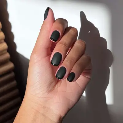All-black French manicure with matte base and glossy tips