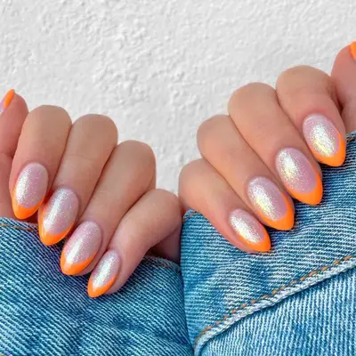 French manicure with shimmering neutral base and neon orange tips