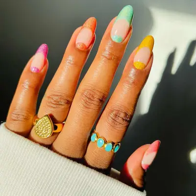 French manicure with neutral base and rainbow velvet tips and cuticle half-moons