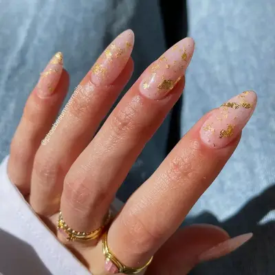 Sheer pink nails with gold flakes