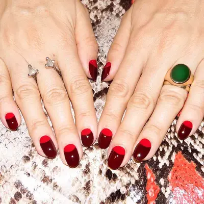 A cranberry manicure with red half moon cuticles