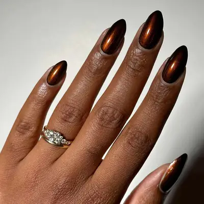 A glossy metallic brown manicure