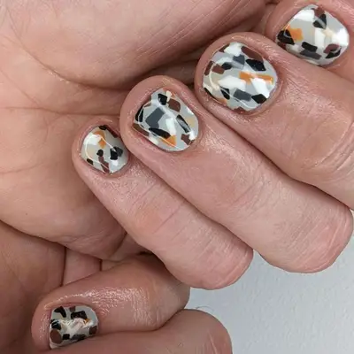 A manicure with a gray base and abstract accents