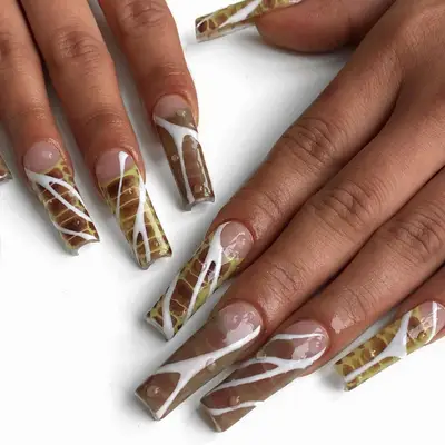 A square snakeskin manicure with white accents