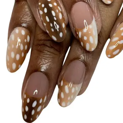 A deer print manicure in shades of brown and white