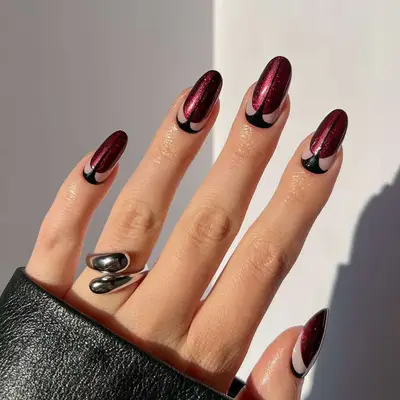 A burgundy manicure with black art deco details