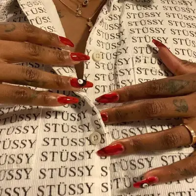 A burgundy tortoiseshell manicure with an eightball detail