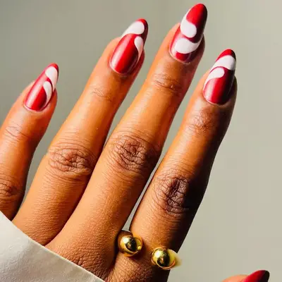 Almond-shaped nails with pink and burgundy heart-accented manicure