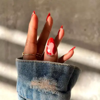 A manicure with negative space, wavy details, and a white heart accent