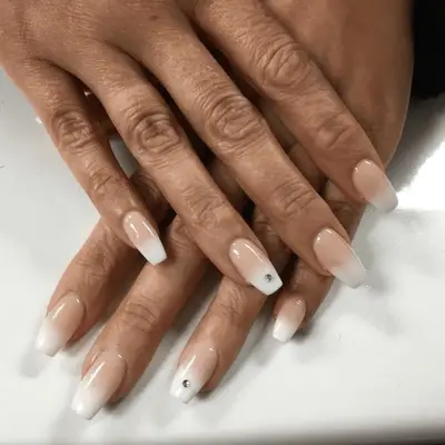 Light pink to white French ombre with corner dots detail