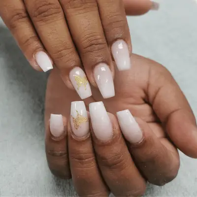 White with pink French ombre manicure with gold butterfly detail