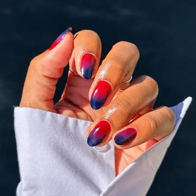 Hand with a brown ombre manicure.