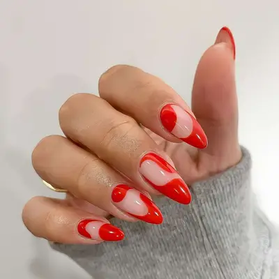 Tomato-red negative space abstract swirl nails