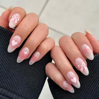 Pink aura nails with emoji-esque accents 