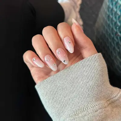 A neutral manicure with gemstone and star details