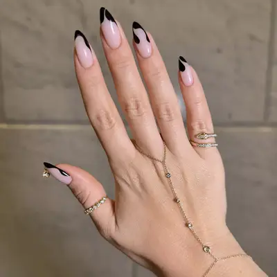 abstract black french mani with nail piercing 