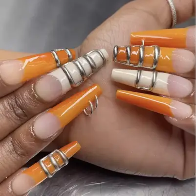 orange and white Coffin nails with 3D silver details and rings