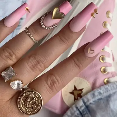 ombrÃ© pink nails with hearts and gold nail piercings