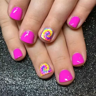 a short pink manicure with tie-dye accent nails