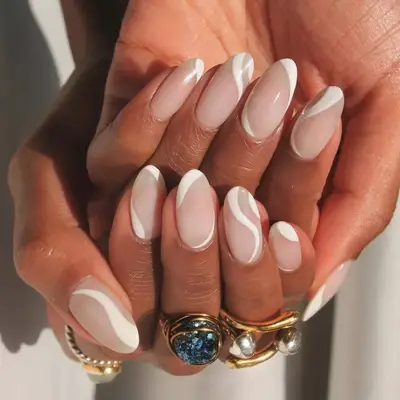 Milky white nails with white swirl designs