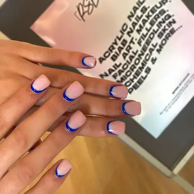 Blue reverse French manicure on short, square nails