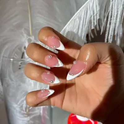 Stiletto white French manicure with oversized pearl details