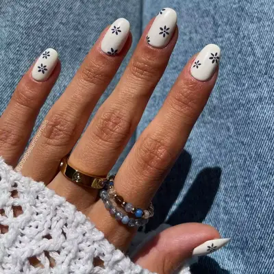 Short white nails with blue floral design
