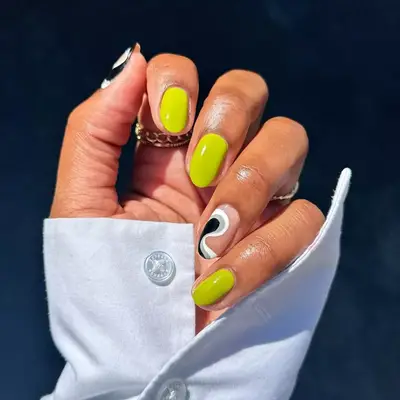 Neon yellow nails with gray and black swirl accent nails