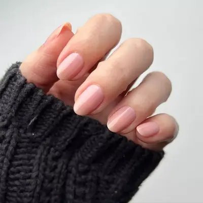 Light peachy pink sheet manicure on almond nails