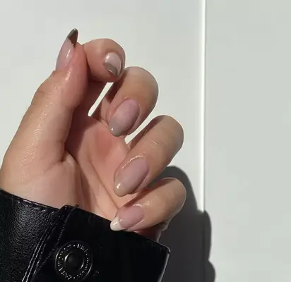 Nude almond-shaped nails with mocha-hued gradient french tips