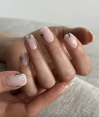 Squoval-shaped nude nails with delicate botanical tips