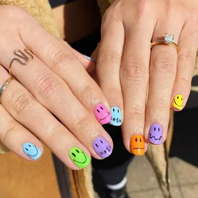 Multicolored nails with different emoji face designs