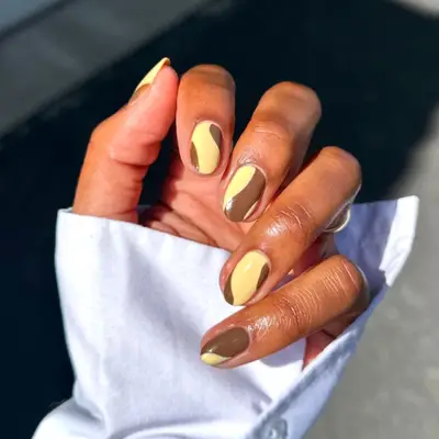 Brown and yellow swirling manicure.