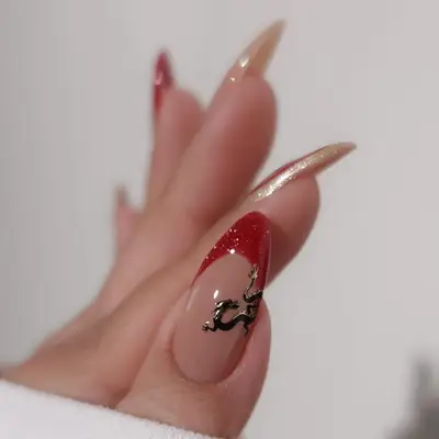 Minimalist red and gold French manicure with black dragon design - MYM Beauty Lunar New Year Nail Ideas