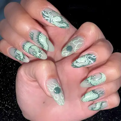 Mint green manicure with dragon designs - MYM Beauty Lunar New Year Nail Ideas