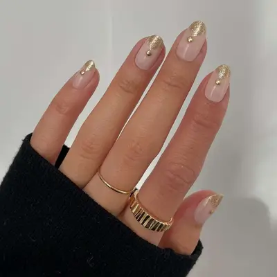 Manicure with neutral base and subtle gold shimmer polish - MYM Beauty Lunar New Year Nail Ideas