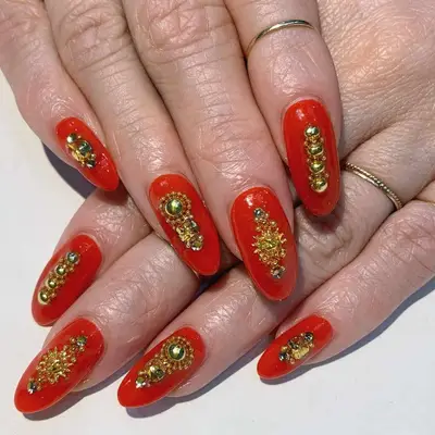 Red nails with gold jewels - MYM Beauty Lunar New Year Nails