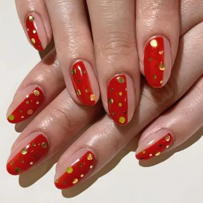 Half-and-half red and neutral nails with gold dot design - MYM Beauty Lunar New Year Nail Ideas