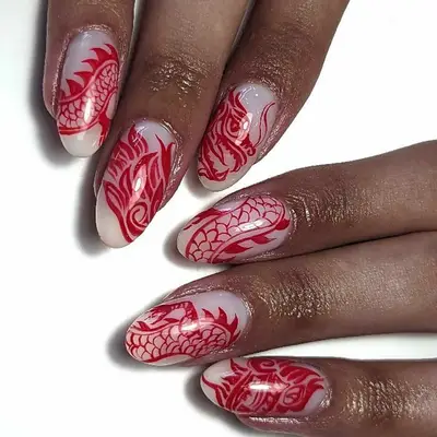 Manicure with white base and red dragon design - MYM Beauty Lunar New Year Nail Ideas 
