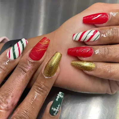 Red and green striped nails with sweater and gold accents