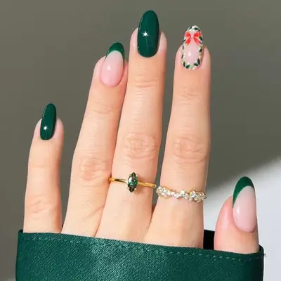 A glossy evergreen manicure with one red bow