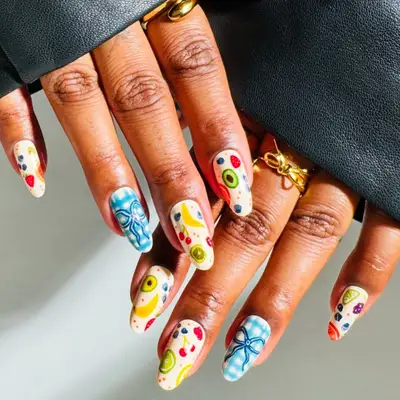 Long almond-shaped nails with fruit salad detail
