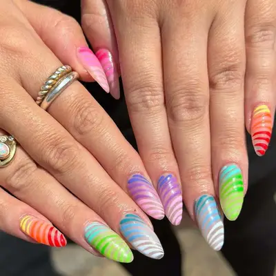 Almond nails with rainbow colors and design.