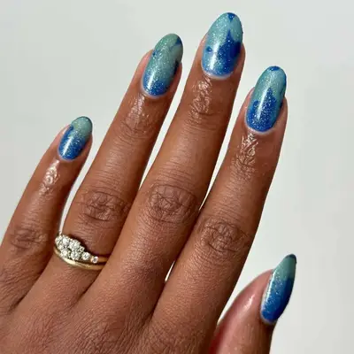 Manicure with blue glitter polishes 