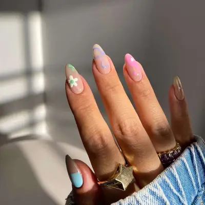 Nude nails with daisies and peace sign designs