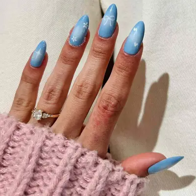 Almond nails with baby blue airbrush nail art 