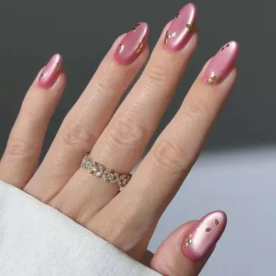 Glass nails with mauve polish and gold foil details.