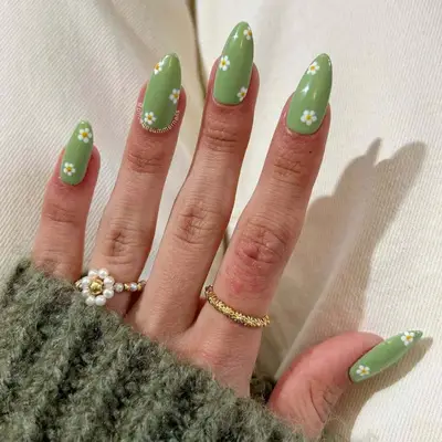 Sage green nails with daisy nail art
