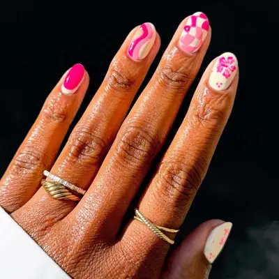 Short nails with mixed pattern nail art in pink and cream